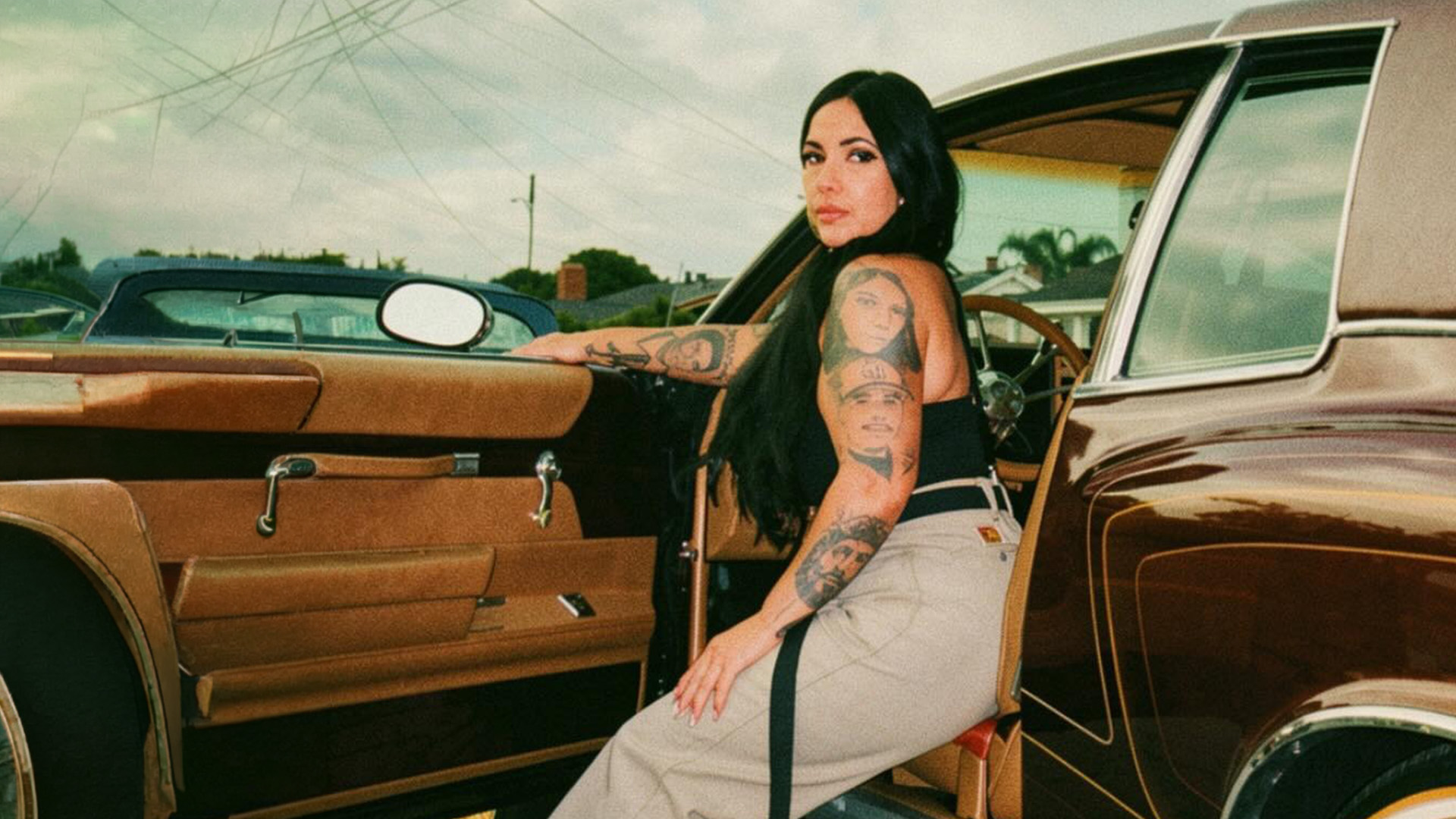 Chula Cholita founder Erica beside a classic car in Seaside