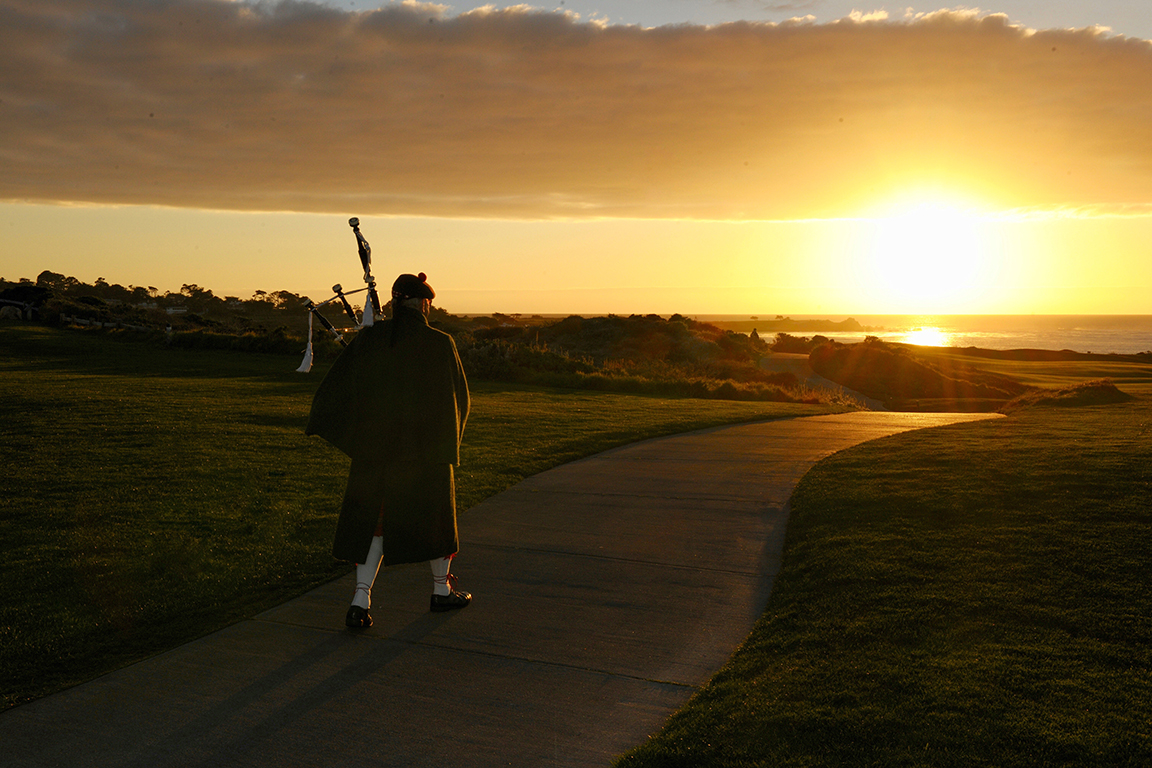 Gina Taro photograph of a bagpiper at sunset on the coast